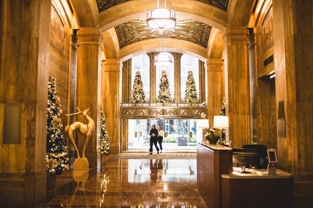 White and Gold christmas trees with reindeer holiday decor in a hotel lobby