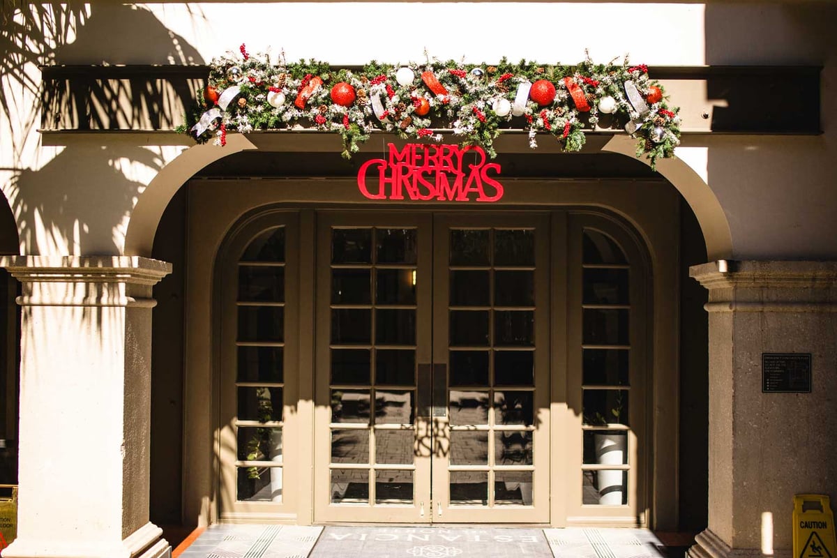 red and white garland with merry christmas sign