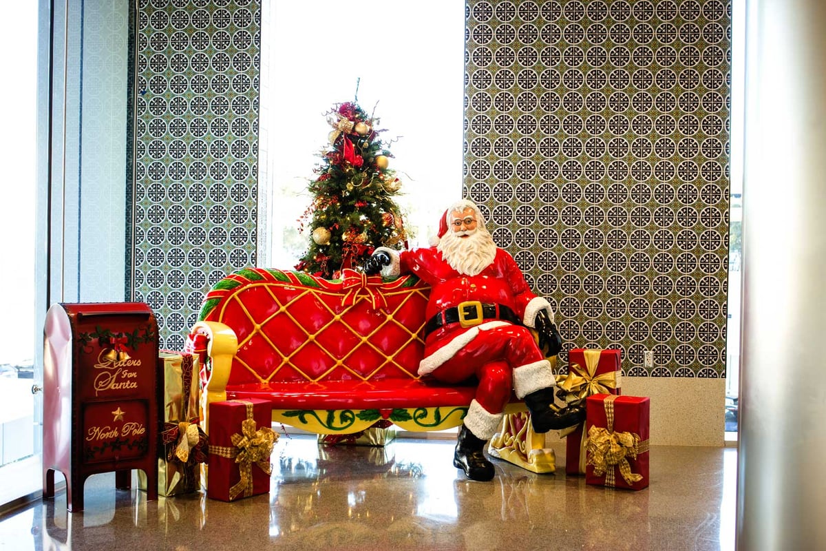 Red and gold christmas tree with santa and gift box decor