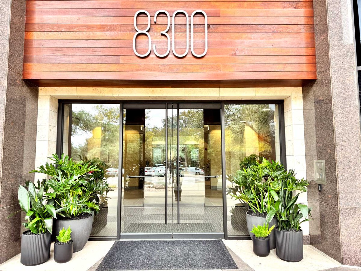 A variety of exterior plants outside an office door 