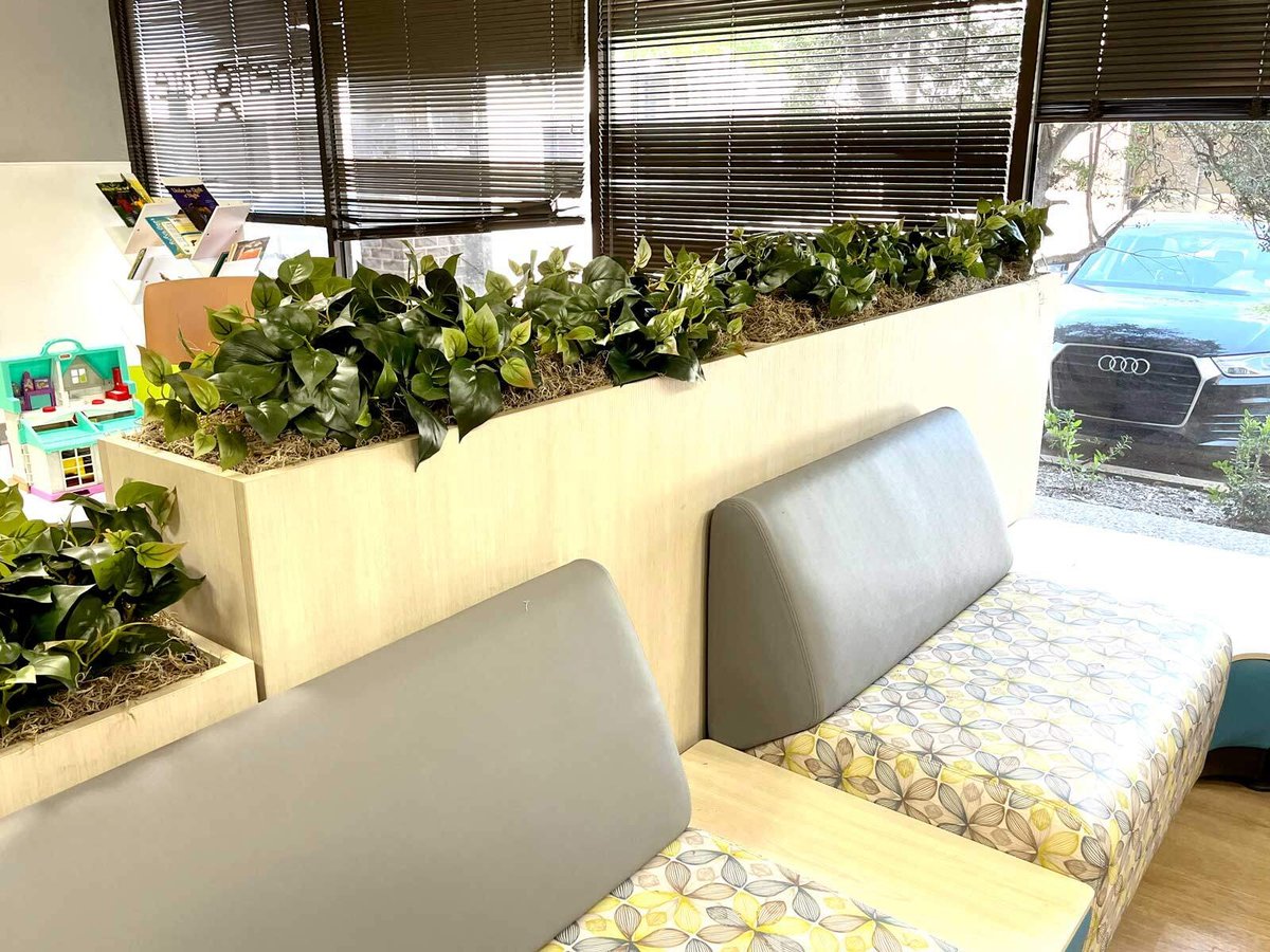 Clinic waiting room with replica / faux Pothos Ivy in built-in planters