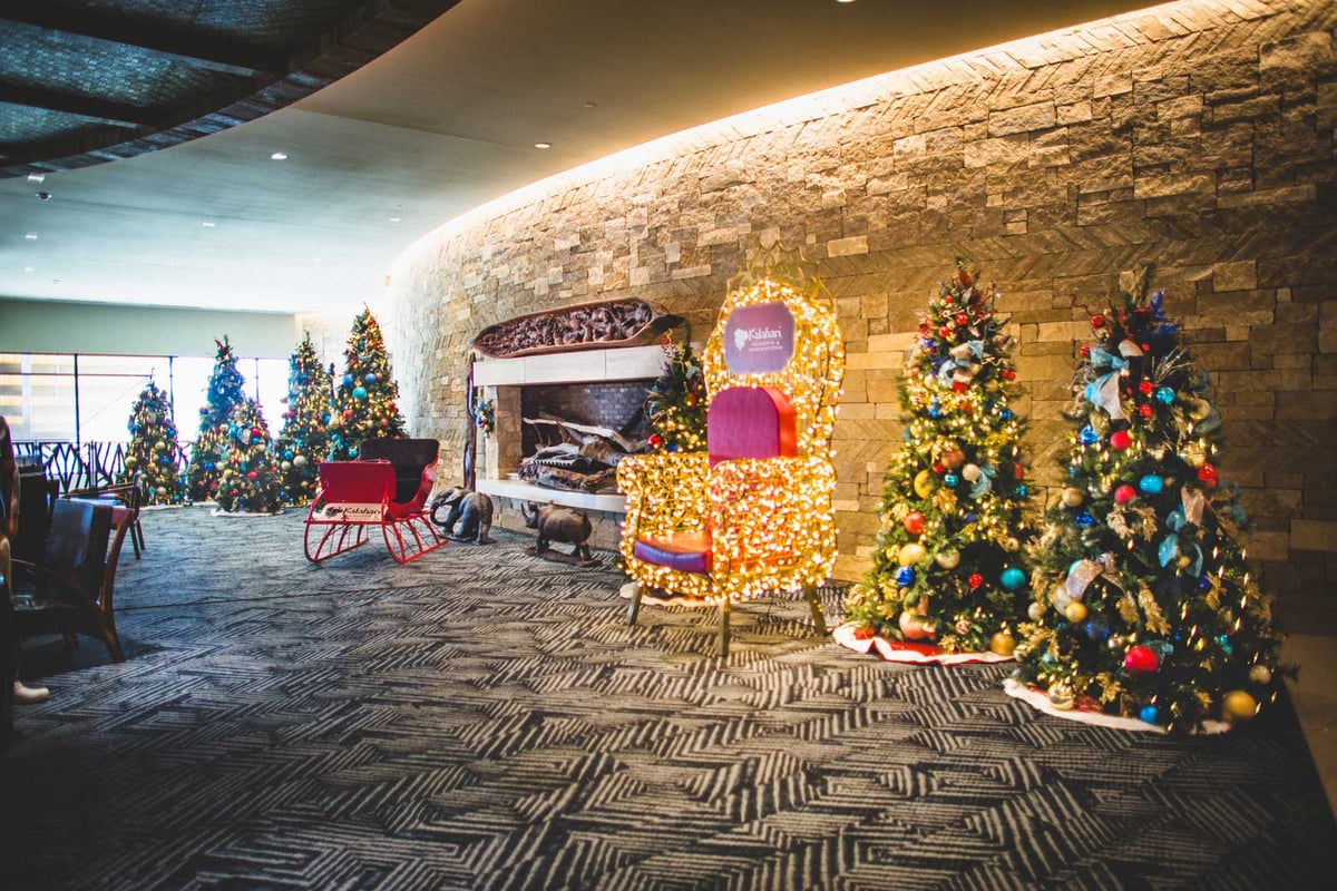 Kalahari: an Austin TXhotel with bright, multi-colored Christmas trees and a large, lighted Santa chair