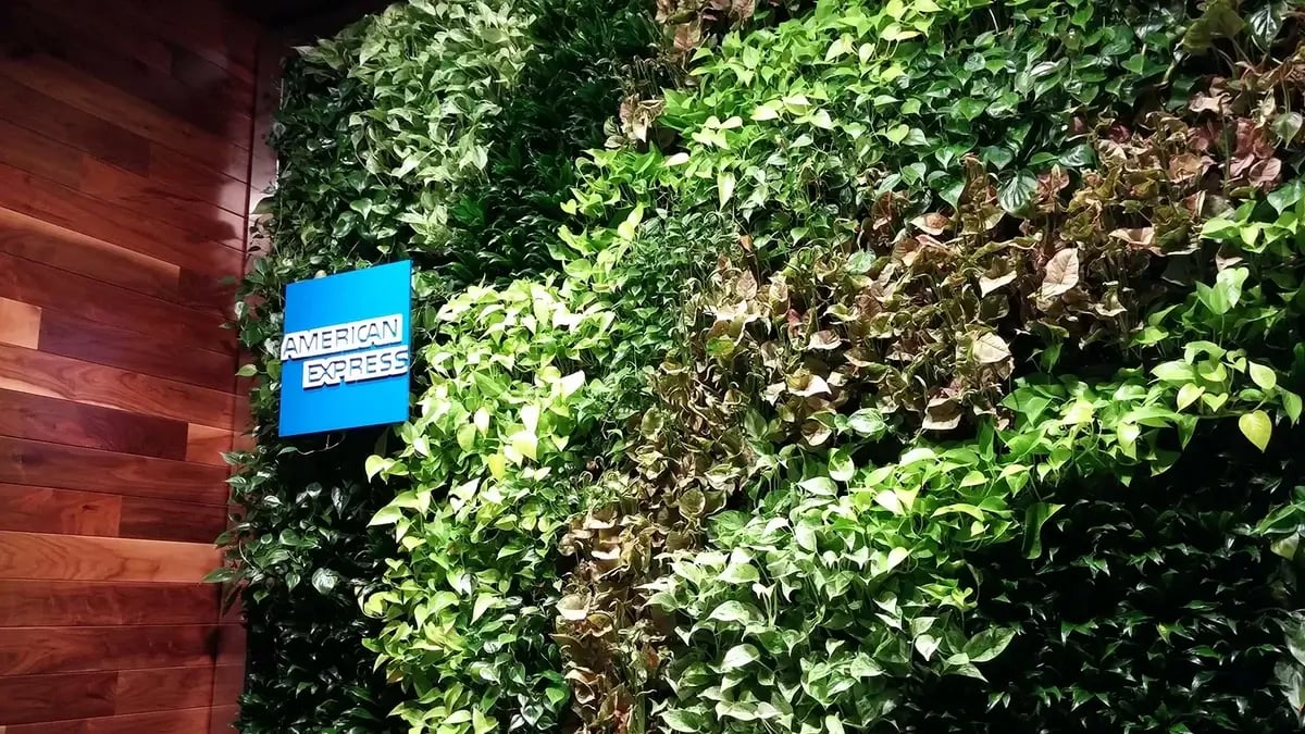 living wall inside an office lounge with brand logo / signage
