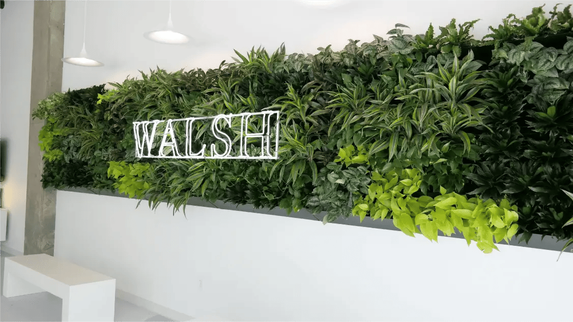 Living wall with brand logo / signage, interior